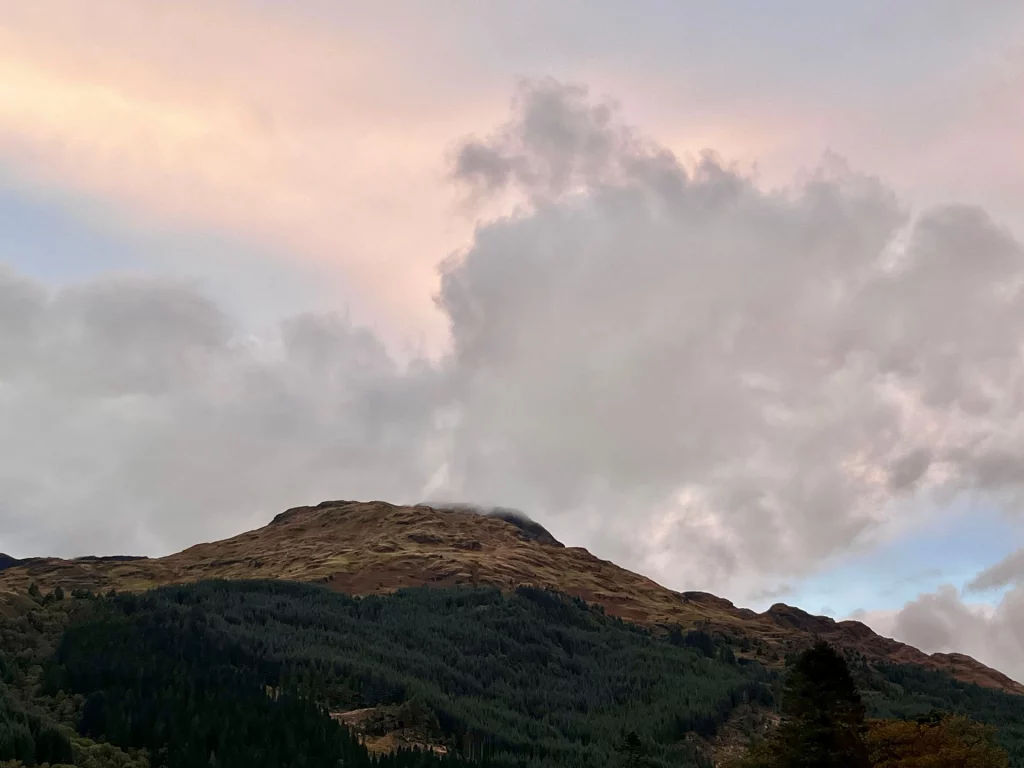 Blick auf den wolkenverhangenen Gipfel des Beinn an Lochain in Argyll and Bute, dessen steile Hänge in den schottischen Highlands in mystischen Nebel getaucht sind.